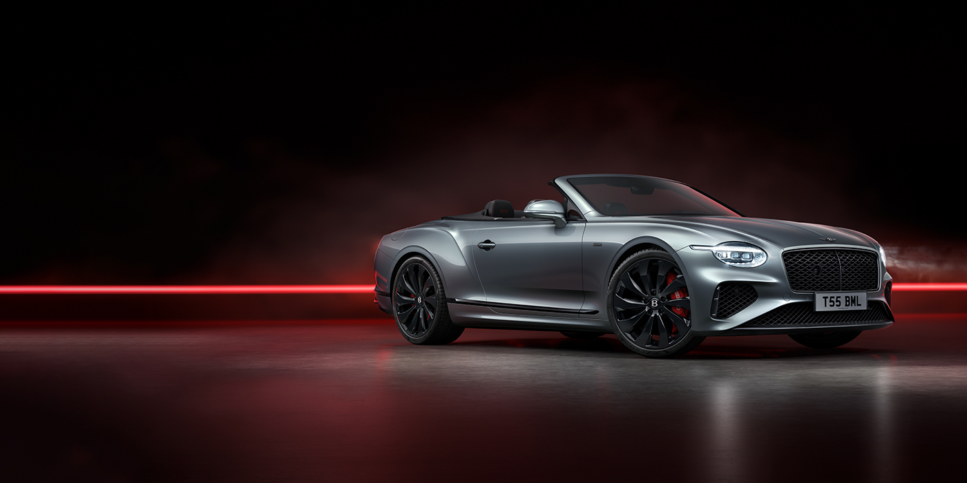 Bentley Rotterdam Bentley Continental GTC Black Edition convertible front three quarters in Hallmark silver against a dark grey and red background