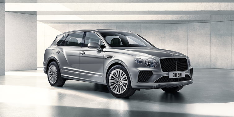 Bentley Rotterdam Bentley Bentayga Extended Wheelbase SUV front three quarter in Moonbeam paint with a grey background