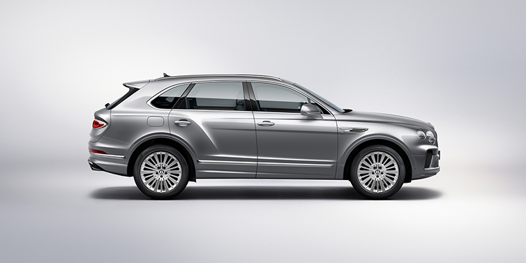 Bentley Rotterdam Bentley Bentayga SUV side profile in Moonbeam silver paint against white background featuring 21 inch 5 spoke wheels